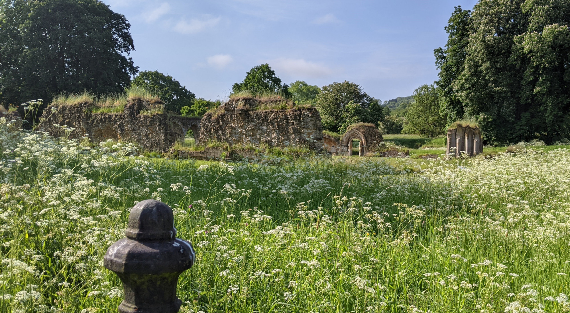 English field with abbey ruins
