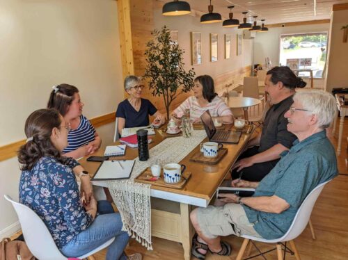 Time Bank team sits around a table